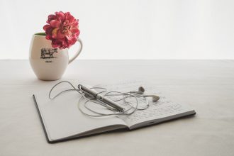 journal, headphones, and mug